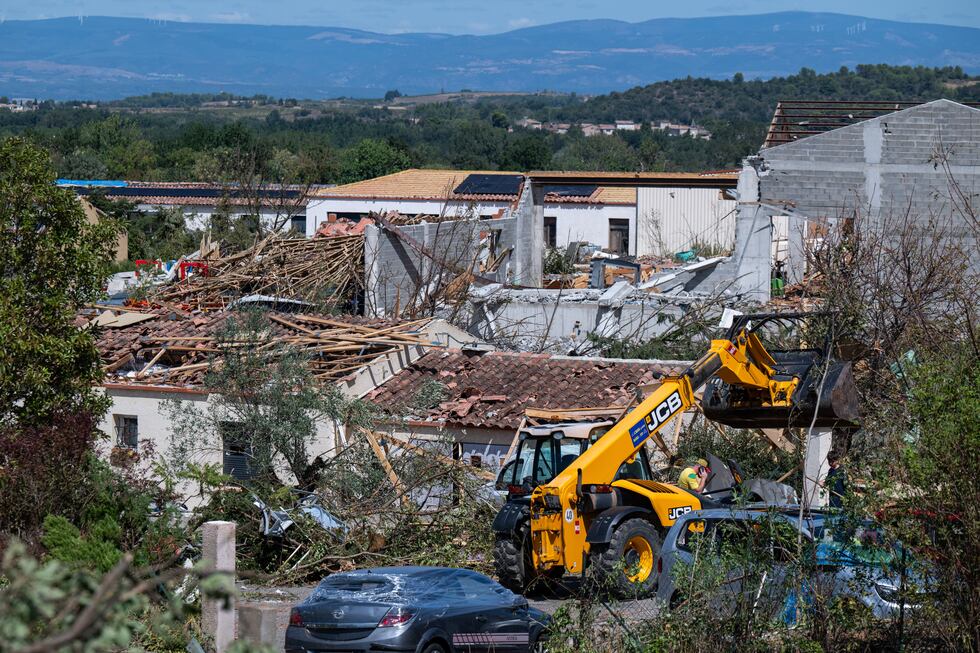 Damaged houses are pictured after a tornado ravaged the small village of Pomas in southern...