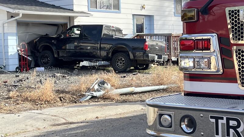 A black Ford F250 crashed into a house.