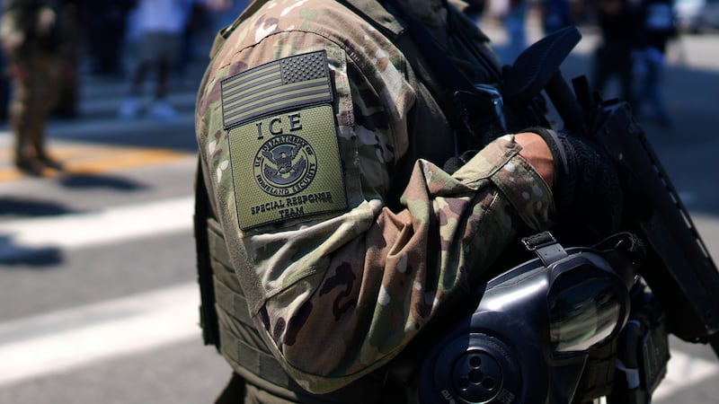 An ICE Special Response Team member stands guard outside the Metropolitan Detention Center,...